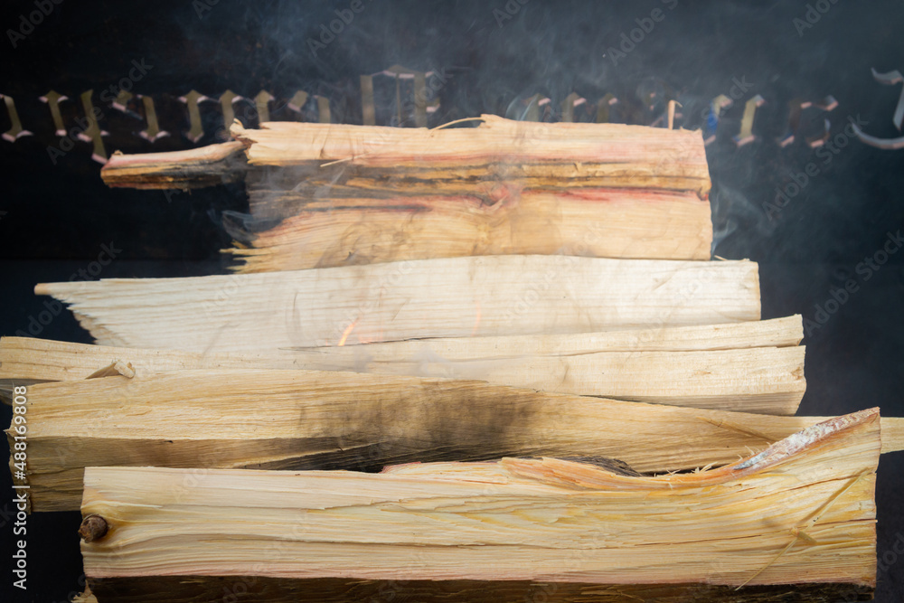 Dry wood in the grill for kindling and making coals