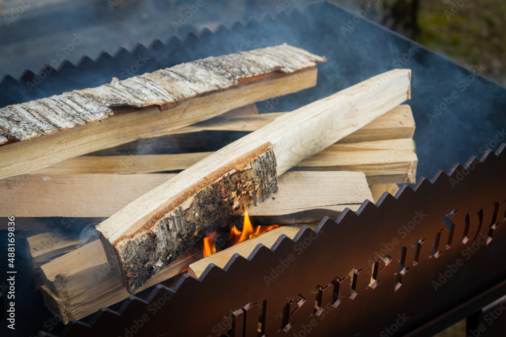 Dry wood in the grill for kindling and making coals