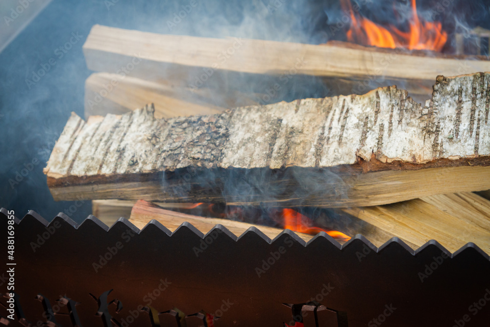 Dry wood in the grill for kindling and making coals
