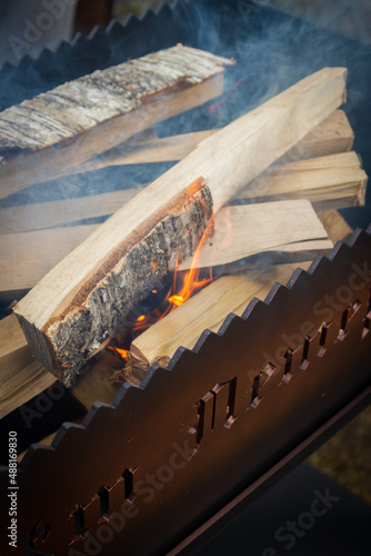 Dry wood in the grill for kindling and making coals
