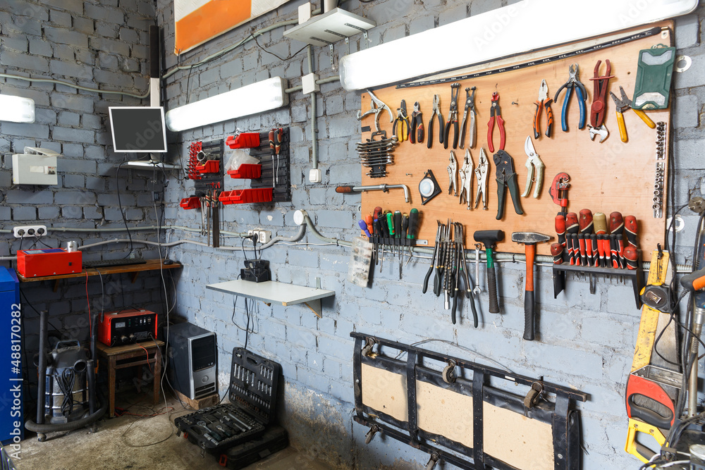 Naklejka premium A set of tools in the real auto repair shop.