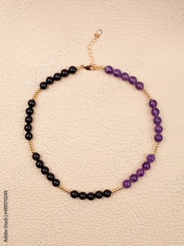Women`s necklace of black and purple gem stones
