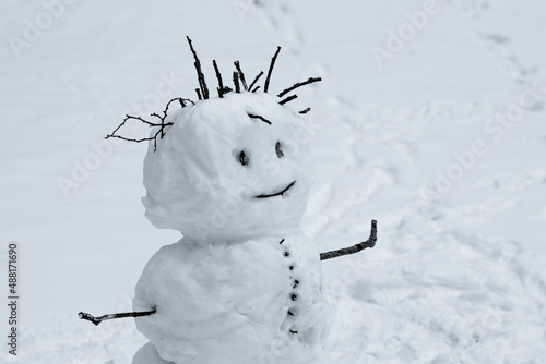 Big ugly snowman in winter. Snowman with creepy face and hair