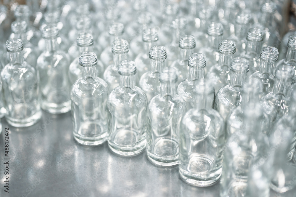 Group of glass bottles for alcohol drink on metal table Group of glass bottles for alcohol drink on metal table