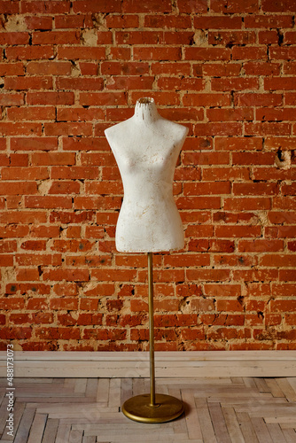 white mannequin on orange brick wall background