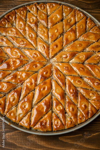 Baklava with nuts on a wooden background. Selective focus.