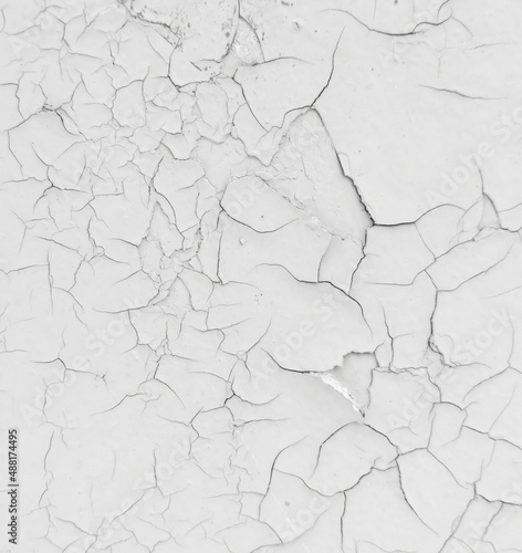 Cracked white paint on the wall as an abstract background.