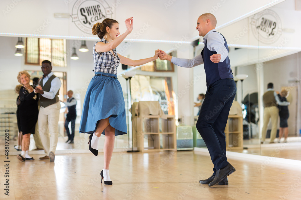 Pair dancing lindy hop during rehearsal