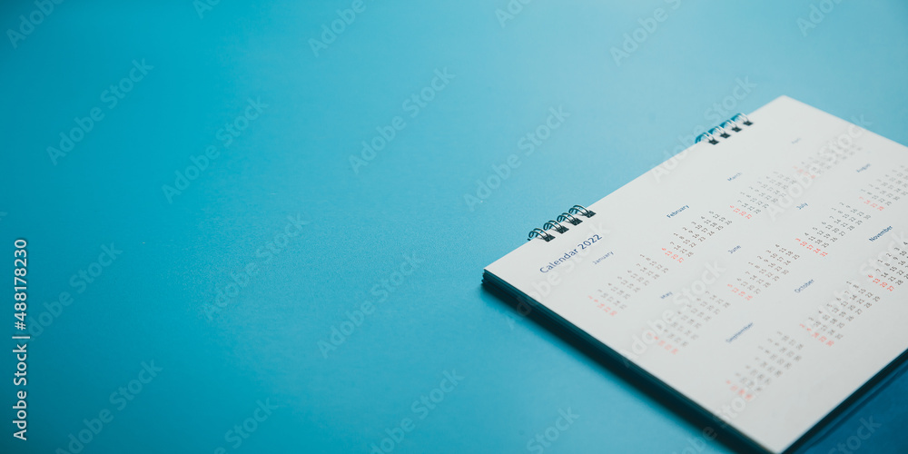 Close top view on white calendar 2022 month schedule Work planning and life concept. Close top view on white calendar 2022 month schedule Work planning and life concept.