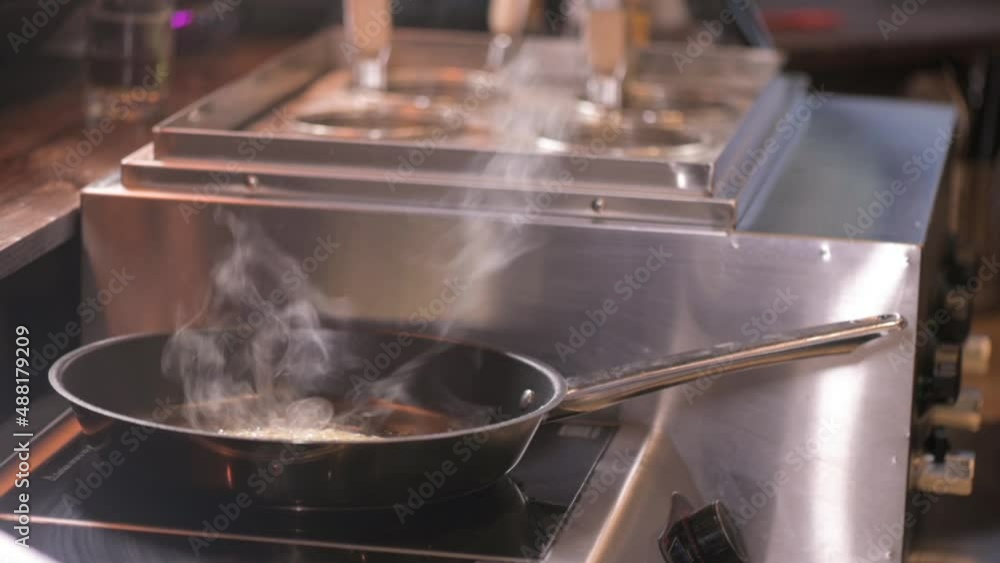 Chef in restaurant is frying pasta ingredients in frying pan. delicious dish made of natural products for healthy lifestyle. Chef in restaurant is frying pasta ingredients in frying pan. delicious dish made of natural products for healthy lifestyle.
