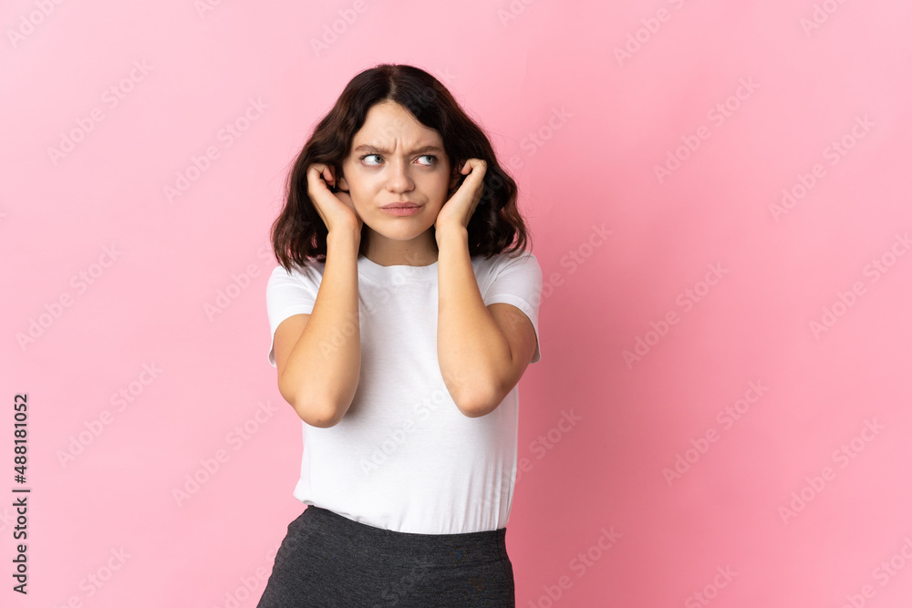 Teenager Ukrainian girl isolated on pink background frustrated and covering ears Teenager Ukrainian girl isolated on pink background frustrated and covering ears