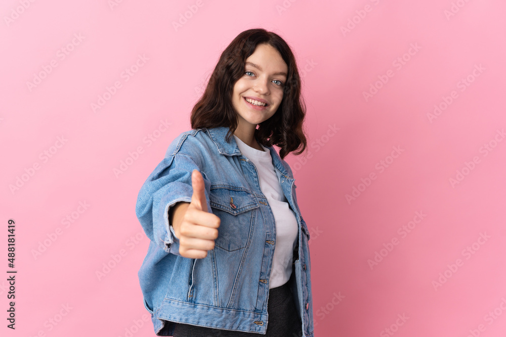 Teenager Ukrainian girl isolated on pink background with thumbs up because something good has happened Teenager Ukrainian girl isolated on pink background with thumbs up because something good has happened
