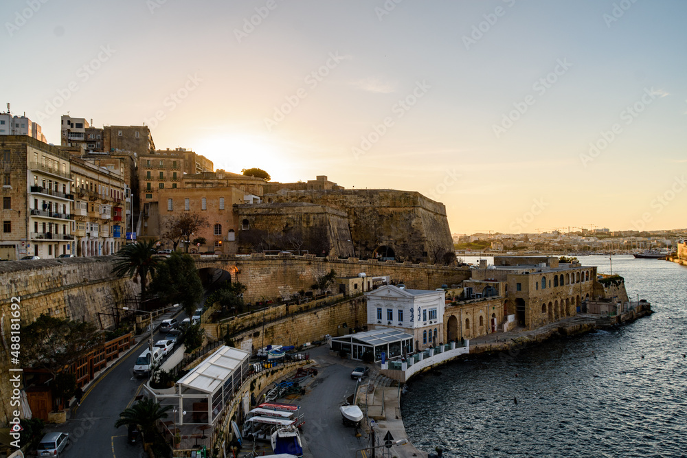 Sunsetting behind Saint Andrew's Bastion on the Marsamxett Harbour side of Valletta, Malta.