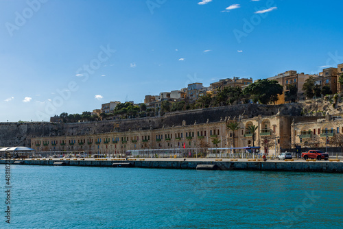 In front of the Floriana Lines fortifications are the old stores and warehouses at the Valletta Waterfront in Floriana, Malta, next to the Grand Harbour. photo