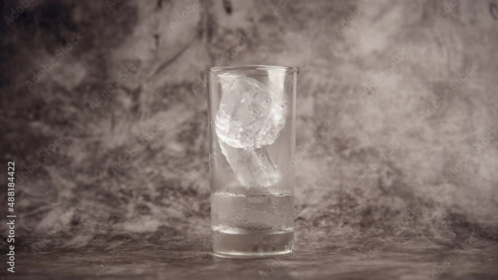 Ice melting. Fast melting video of ice in a glass. Ice quickly turns into water. water solubility concept Ice melting. Fast melting video of ice in a glass. Ice quickly turns into water. water solubility concept