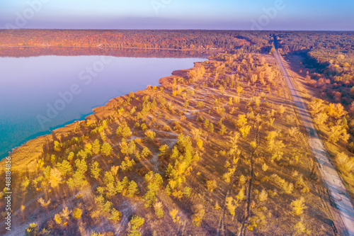 Aerial view of the road along the lake at sunset