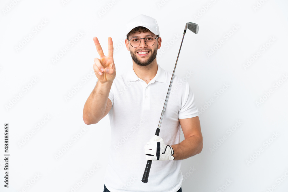 Handsome young man playing golf isolated on white background smiling and showing victory sign Handsome young man playing golf isolated on white background smiling and showing victory sign