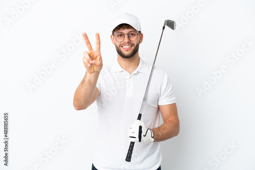 Handsome young man playing golf isolated on white background smiling and showing victory sign