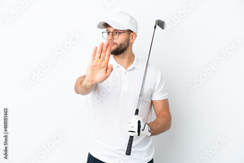 Handsome young man playing golf isolated on white background making stop gesture and disappointed