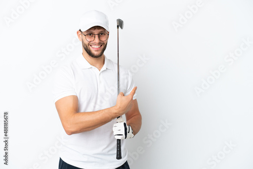 Handsome young man playing golf  isolated on white background pointing back