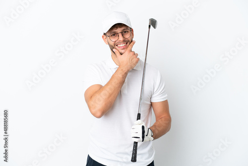 Handsome young man playing golf isolated on white background happy and smiling