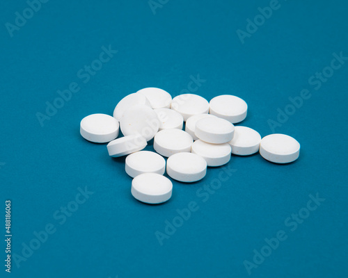 Medcine white pills aspirin pharmacy on blue background