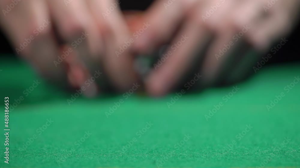 Red and black chip stacks on green gaming table. Man playing bet all in. Red and black chip stacks on green gaming table. Man playing bet all in.