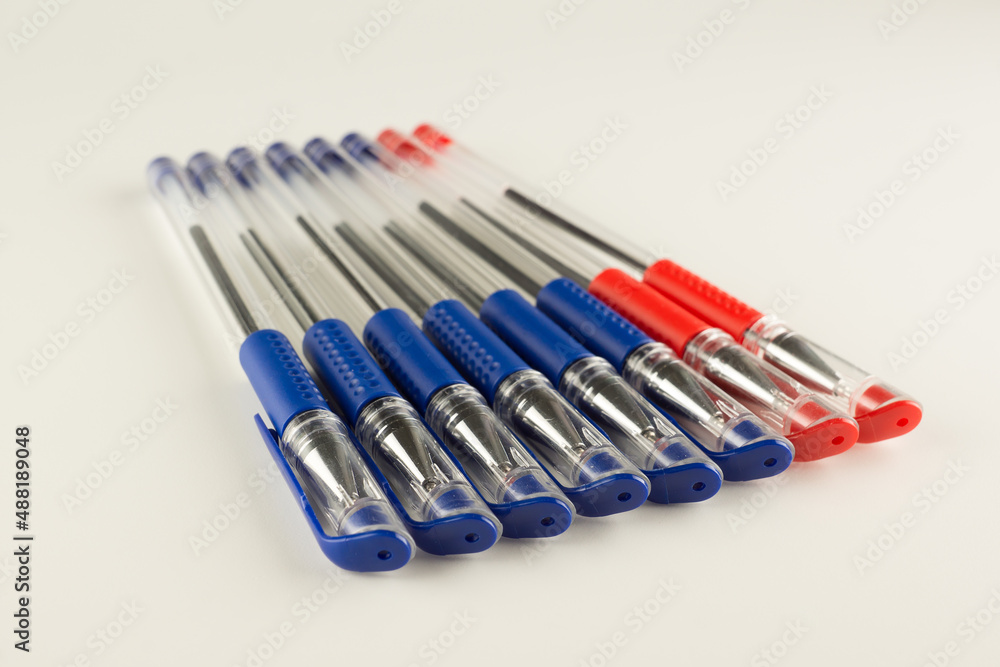 set of blue ballpoint pens lined up hardly