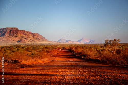 One of the most beautiful red dirt-roads in the Karijini National Park in Western Australia at sunset. photo