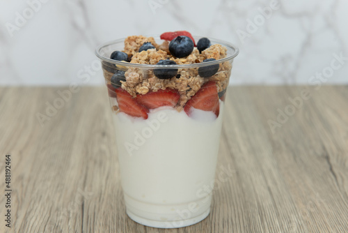 Complete meal contained in this cup of yogurt, blueberries, strawberries, and granola for plenty of protein and carbohydrates to eat