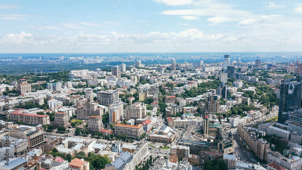 Flying over the buildings of the big city. Aerial view of the cityscape