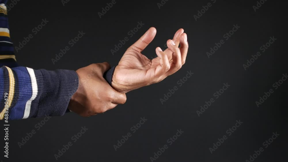 man suffering pain in hand isolated on black man suffering pain in hand isolated on black
