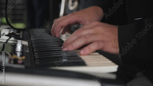 A man's hands play the piano
