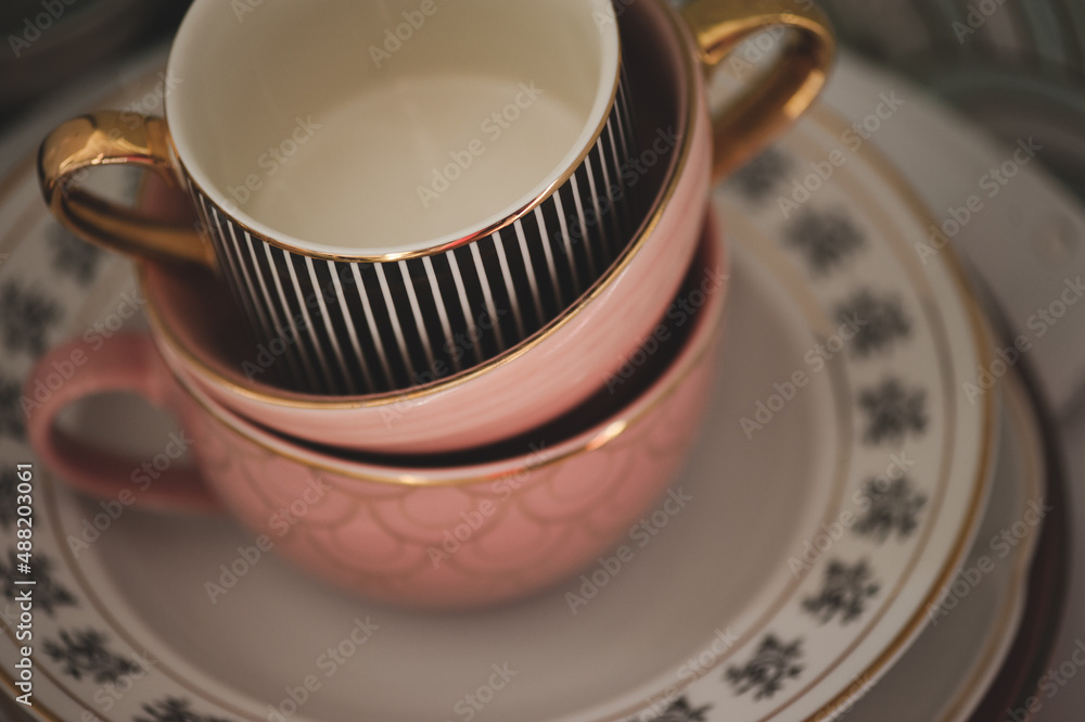 Stack of stylish ceramic cups closeup in kitchen. Colorful dishes. Stack of stylish ceramic cups closeup in kitchen. Colorful dishes.
