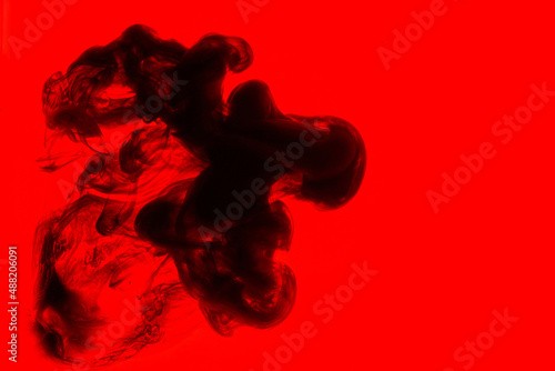 Black and red ink background, colorful fog, abstract swirling ocean, acrylic paint pigment underwater, dark smoke