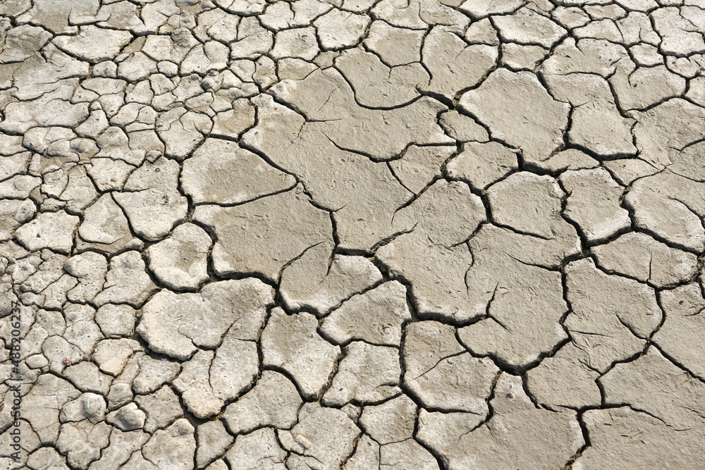 Cracked soil due to the long dry season. Rivers, lakes or ponds can dry and crack like this to form an irregular circle or hexagon pattern. Droughts like this often occur in African countries Cracked soil due to the long dry season. Rivers, lakes or ponds can dry and crack like this to form an irregular circle or hexagon pattern. Droughts like this often occur in African countries