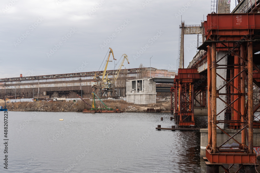 Kyiv (Kiev), Ukraine - February 19, 2022: Big marine cranes near Dnipro river, industrial area, territory Kyiv (Kiev), Ukraine - February 19, 2022: Big marine cranes near Dnipro river, industrial area, territory