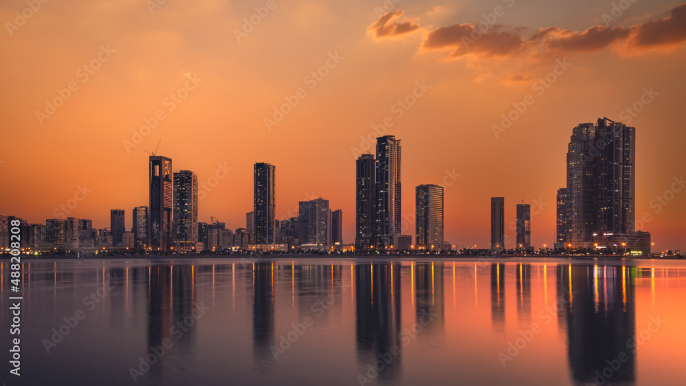 sharjah waterfront country skyline at dusk united arab emirates