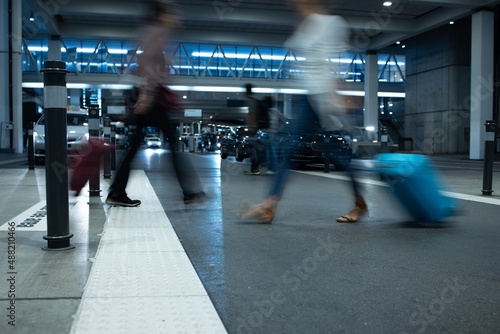 People at an international airport, at the baggage claim zone - motion blurred image