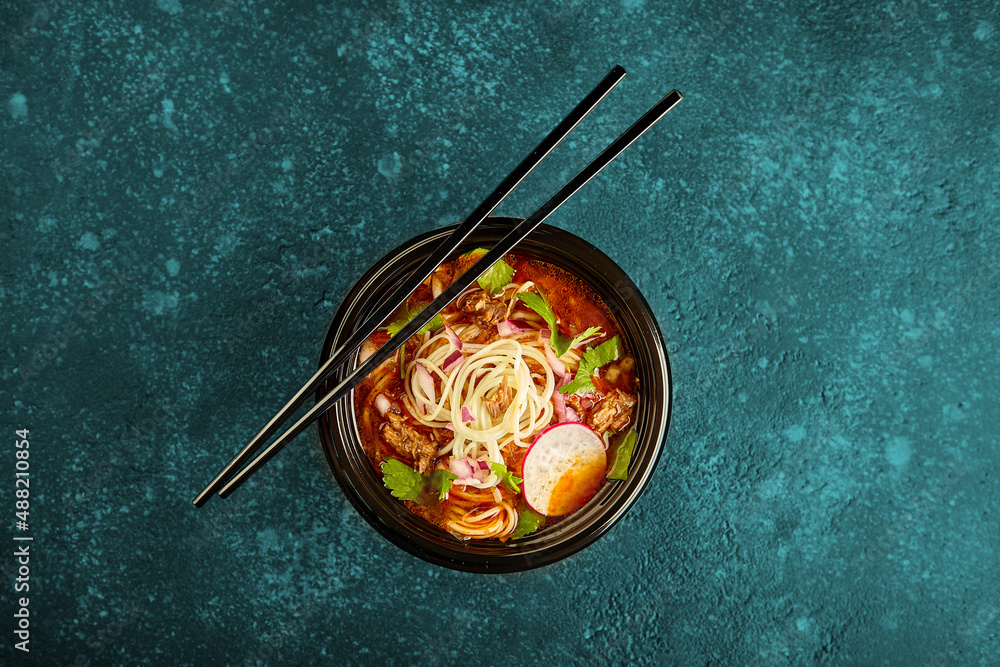 Birria ramen, consomme soup with beef and noodle. Mix of Mexican and