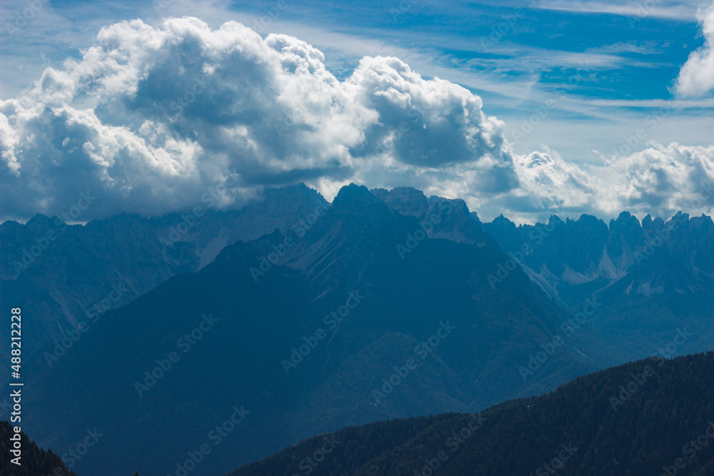 Blue mountain landscape. View on the eastern Marmarole (Cadore, Italy) painted in blue tones under the cloudy sky. To use as a background. Blue mountain landscape. View on the eastern Marmarole (Cadore, Italy) painted in blue tones under the cloudy sky. To use as a background.
