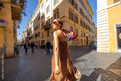 Photography Lifestyle portrait of a woman running on cozy streets in old town of Rome