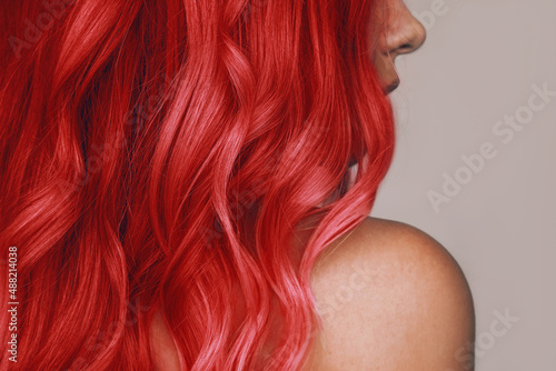 Canvas Print Close-up of the wavy hot red hair of a young woman isolated on a beige background