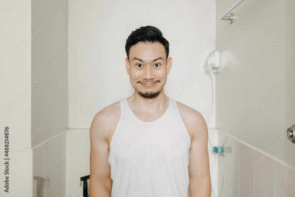 Funny face expression of Asian man try to poop in the toilet. Stock