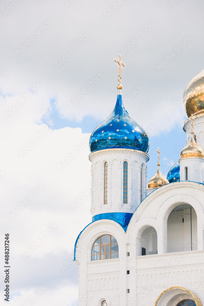 Blue and golden domes of white orthodox church