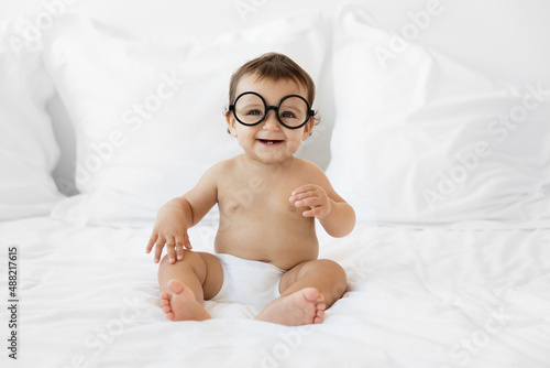 Laughing baby with round-shaped goggles photo