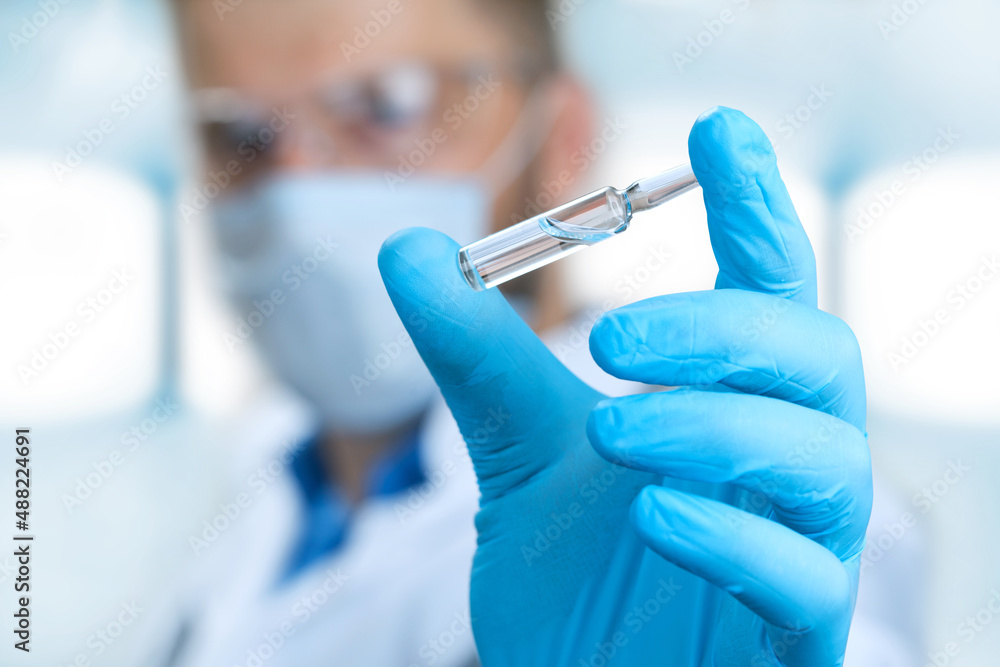 Doctor holding a viol with vaccine against corona virus. Doctor holding a viol with vaccine against corona virus.