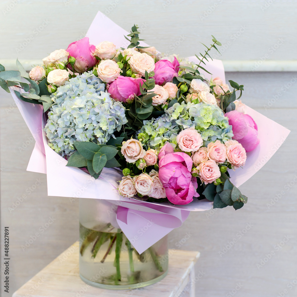 Wedding bouquet of pink roses, lilac hydrangea, pink tulips and