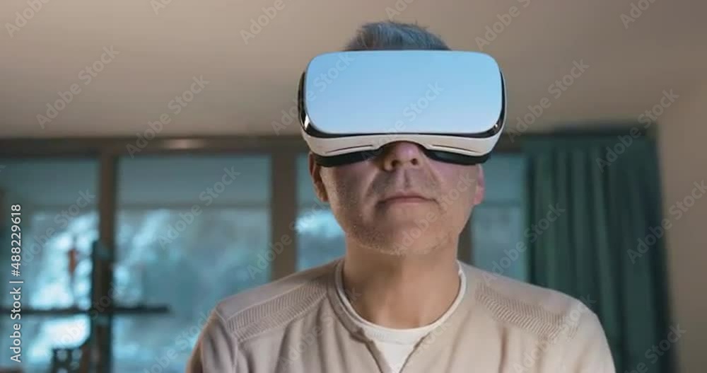 Man wearing a VR headset and experiencing virtual reality Man wearing a VR headset and experiencing virtual reality