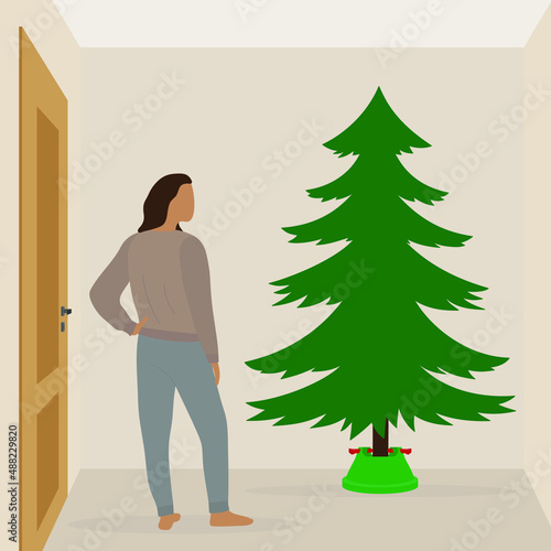 Female character stands and looks at the Christmas tree in the room